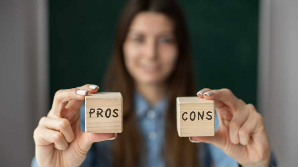 Woman holding Pros and Cons blocks